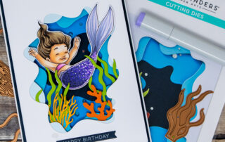 Die cut tunnelscape card featuring Spellbinders Paper Arts Underwater Tunnel die set and a Copic marker coloured mermaid digital stamp from Sweet November Stamps.