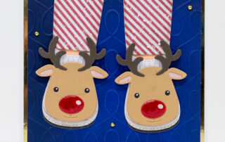 Die cut Christmas card inspiration featuring Spellbinders Paper Arts products including October 2024 Club Cozy Toes Slippers etched die set.