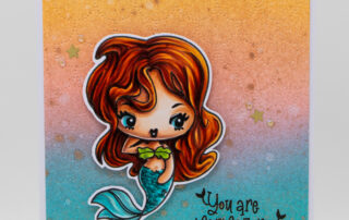 Card inspiration & Copic marker colouring video featuring The Greeting Farm Cheeky Mermaids clear stamp set.