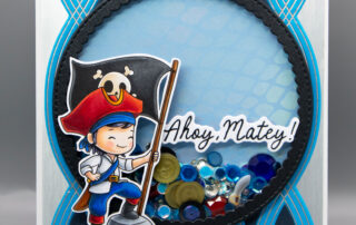 Handmade shaker card inspiration featuring Sweet November Stamps A Wee Bit of Piracy clear stamp set coloured using Copic markers.